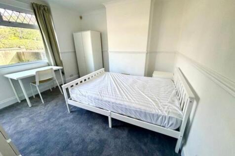 A spacious and bright double bedroom featuring ...