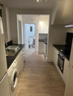 A spacious and modern kitchenette featuring sle...