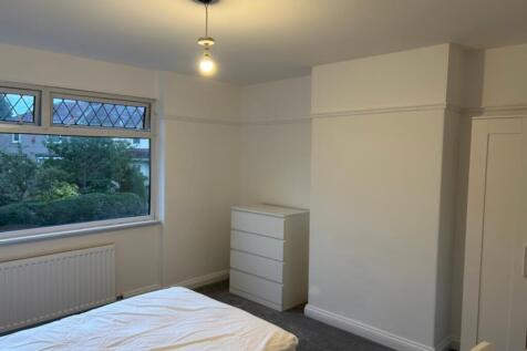 A bright and spacious double bedroom with ample...