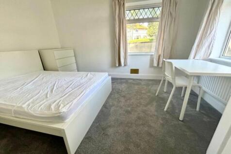 A bright and spacious double bedroom with moder...