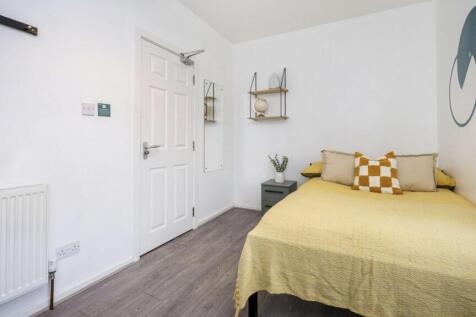 A bright and inviting double bedroom featuring ...