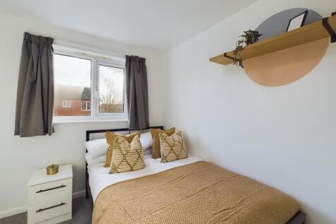 A bright and inviting double bedroom featuring ...
