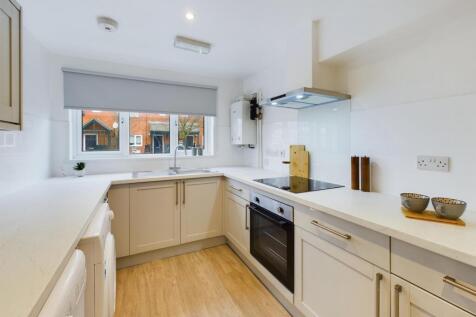 A bright and modern kitchen with ample counter ...