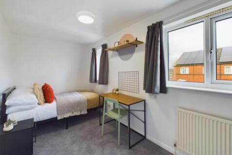A bright and inviting double bedroom with moder...