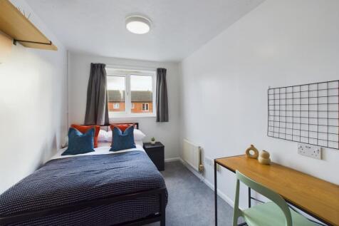 A bright and inviting double bedroom featuring ...