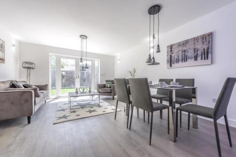 A bright and inviting living room featuring lar...