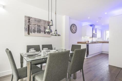 A stylish kitchen and dining area featuring mod...
