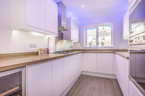 This modern kitchen features sleek cabinetry, a...