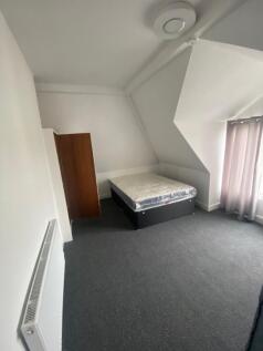 Spacious double bedroom featuring a comfortable...