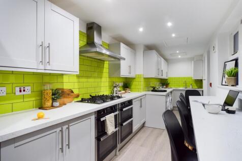 A modern and vibrant kitchen featuring sleek ca...