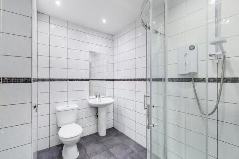 A modern and pristine bathroom featuring a spac...