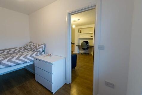 This inviting double bedroom features a cozy be...
