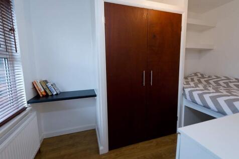 This inviting double bedroom features a cozy sl...