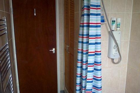 This well-maintained bathroom features a modern...