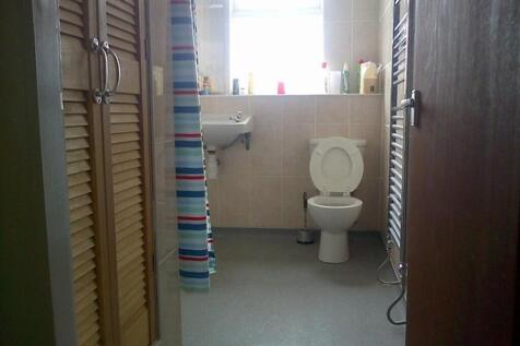 Bright and tidy bathroom featuring a modern sin...