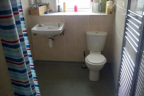 This well-maintained bathroom features a modern...