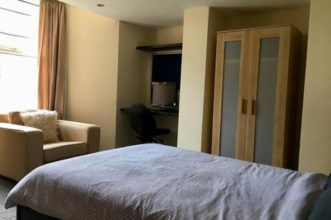 Spacious double bedroom featuring a cozy seatin...