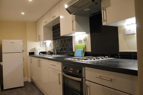 A modern kitchen featuring sleek cabinetry and ...