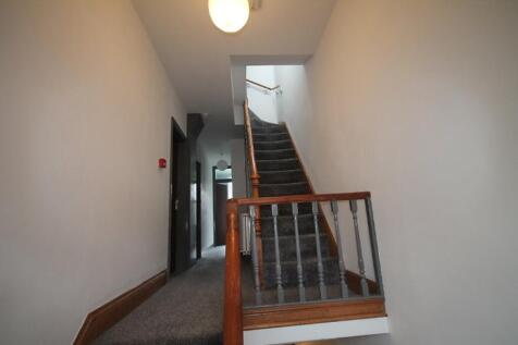 A well-maintained staircase with a bright atmos...