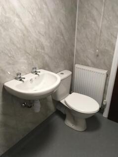A compact and functional single toilet area fea...