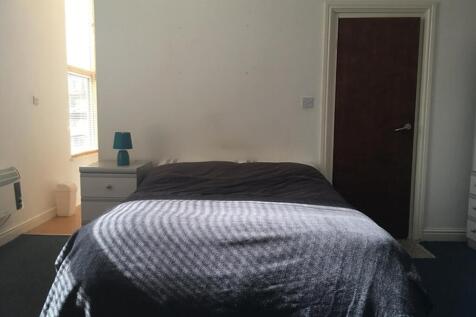 A cozy double bedroom with ample natural light ...
