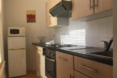 Bright and modern kitchen featuring sleek cabin...