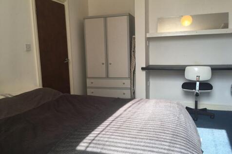 A cozy double bedroom featuring ample natural l...