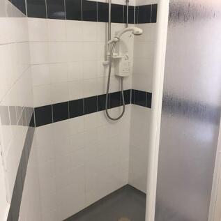 A well-maintained shower space featuring modern...
