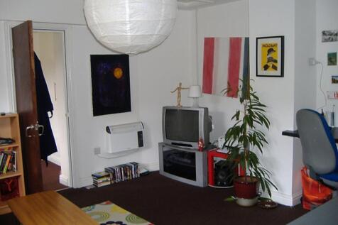 This vibrant living room features a cozy atmosp...