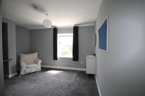 Bright and inviting living room featuring large...