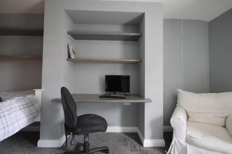 This inviting double bedroom features a cozy be...