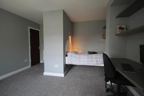 This charming double bedroom features a cozy be...