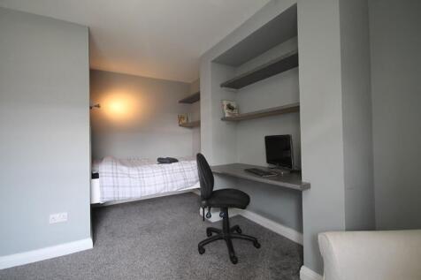 This inviting double bedroom features a comfort...