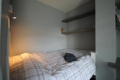 Cozy double bedroom featuring soft lighting, am...