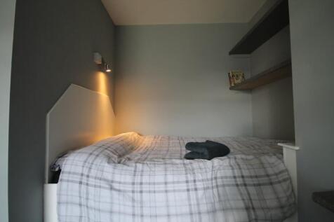Cozy double bedroom featuring a comfortable bed...