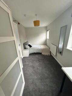 Bright and cozy double bedroom featuring modern...