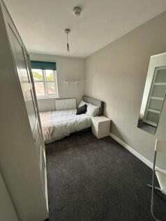 This inviting double bedroom features a comfort...
