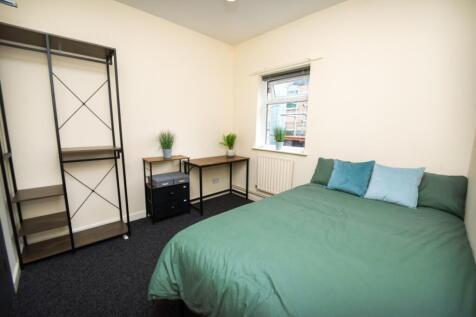 This inviting double bedroom features a cozy gr...