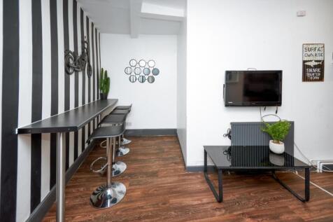This vibrant communal lounge features stylish b...