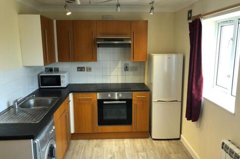 This modern kitchen features stylish wooden cab...
