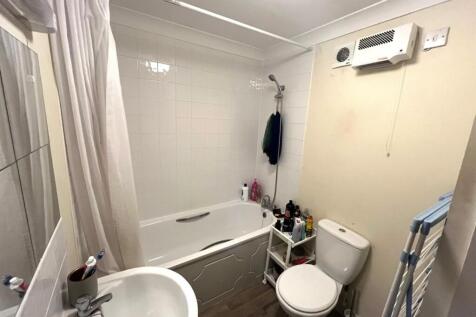 This well-maintained bathroom features a modern...