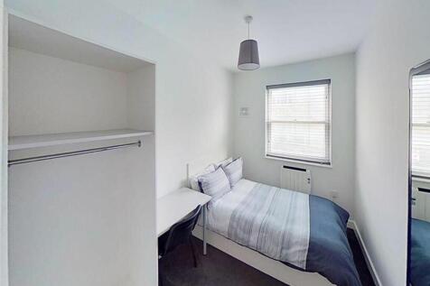 Cozy double bedroom featuring ample natural lig...