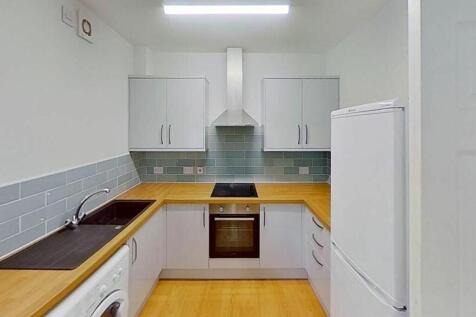This modern kitchen features sleek cabinetry, a...