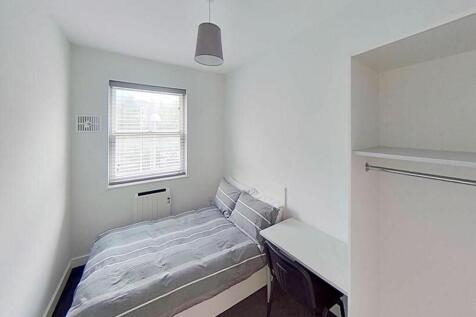 This inviting double bedroom features a comfort...