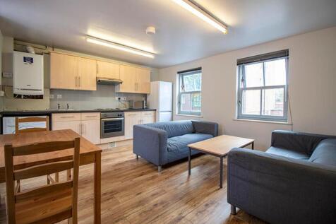 Spacious and modern living room featuring ample...