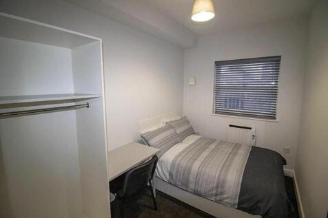 Cozy double bedroom featuring a comfortable bed...