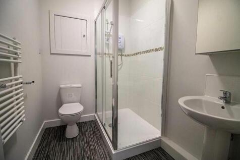 A modern bathroom featuring a spacious shower, ...