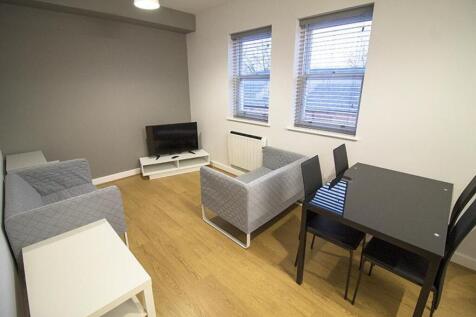 Spacious living area featuring modern furnishin...