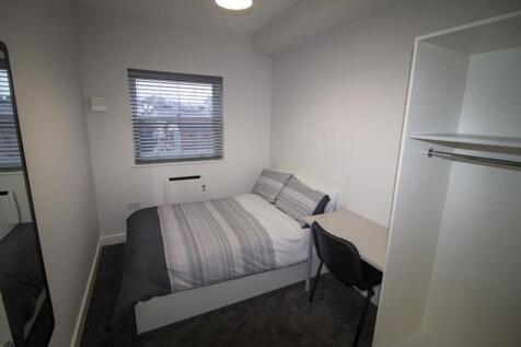 This inviting double bedroom features a comfort...