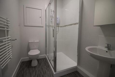 Bright and modern bathroom featuring a spacious...